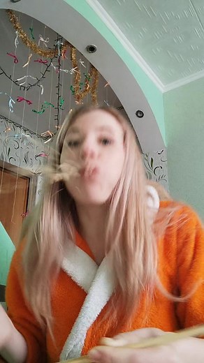 Brushing Long Blonde Hair in a Colorful Room