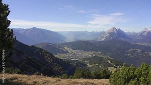 View from the top of Seefelderspitze overlooking Seefeld in Tirol and the mountains of the alps. Austria