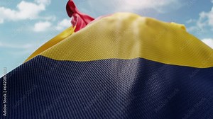 Wavy flag of Chad blowing in the wind in slow motion. Waving colorful Chadian flag team symbol abstract vertical background. Blue sky with clouds. World countries flying flags concept