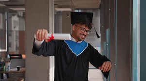 Happy graduate celebrating with diploma in hand