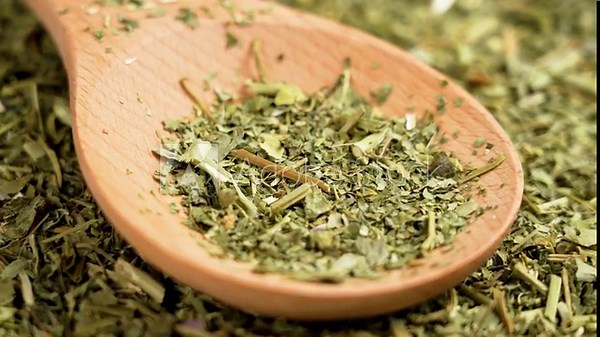 Dried Passiflora herbs for sedative tea. Passion flower organic dry leaves in wooden spoon. Rotation