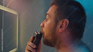 Close-up of a man shaving his beard with a trimmer. Shaving and the beauty of a man without facial hair. High quality 4k footage