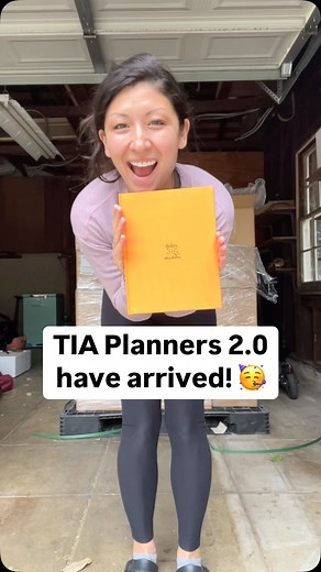 Leila Hanaumi on Instagram: "THE TIA PLANNERS 2.0 ARRIVED! AND THEY’VE ALL BEEN SHIPPED!! 💌🚀🥳 Wanna get your hands on one of these beauties?! Order today at todayiawaken.com! – VD / TRANSCRIPT (Various shots of Leila, an Asian woman, in front of her house, in her garage with the boxes of TIA Planner 2.0, at the post office with her kids) I’m waiting for a very special delivery. (Truck pulls up) I asked them to go around the back. Thankfully the truck fit the alley. It’s so vibrant and beautif