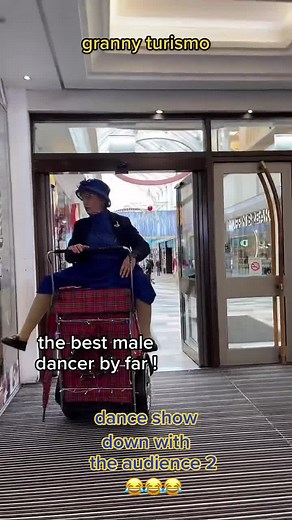Elderly Woman's Joyful Dance Performance in Mall