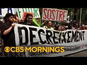 Demonstrators in Spain protest against mass tourism, spraying tourists with water guns