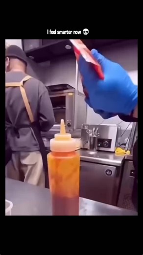 sci || tech || history on Instagram: "The post shares a 24-second video of fast-food workers awkwardly refilling a ketchup squeeze bottle by inverting it on the counter and pouring from individual packets, capturing a moment of mundane inefficiency without any explanatory text. Posted by @explainify.io , an account dedicated to viral, context-free clips of quirky human moments, this video quickly garnered over 1.6 million views and 8,000 likes within hours, sparking humorous reactions on everyda