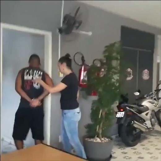 Female police officer handcuffed and arrested a man and taken him into interrogation room.