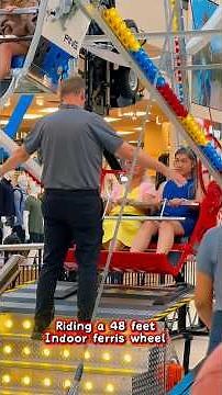 Riding the 48 feet high indoor ferris wheel . Would you ride it too