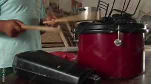 Hands of a Young Boy Playing Drum and Cowbell at his Home in Argentina. Close Up. Stock Video