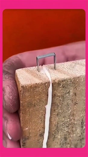 Gluing the split wooden board with wood glue, then clamping it tightly using a strap clamp.