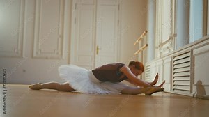 Ballerina dancing in ballet studio. Graceful professional classic ballet dancer woman sitting on floor performing dance elements. Talented choreographer in pointe shoes, tutu. Sport workout training. Stock Video
