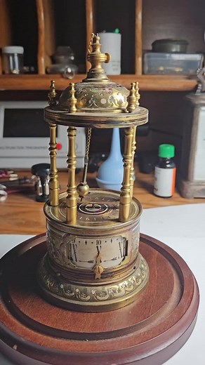 Conical Rotary Pendulum Clock with Annular Dial and Alarm