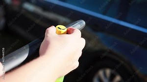 adjusting the supply of foam and shampoo in a high-pressure mini washer. shampoo nozzle, close-up