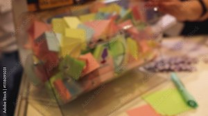 Process of prize drawings, extracting a winning numbers of lottery machine, raffle drum with a bingo balls, bingo machine and winning tickets on event with a female host, hands on lottery machine