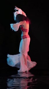 Dancer in oriental costumes dance belly dance on the background