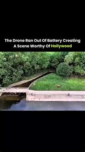Explainiosity on Instagram: "The post features a 21-second viral drone clip capturing a near-cinematic rescue as two men fly a drone over a river before its battery suddenly dies mid-air. The tension spikes as the drone begins free-falling toward the water, with the onboard camera recording the drop in real time. In a split-second reaction, one man sprints forward and dives into the river, stretching out just before impact and catching the drone inches above the surface. The raw timing, unplanne