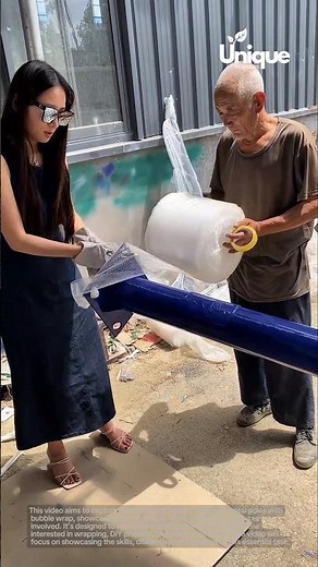 Wrapping metal poles: people protecting metal poles with bubble wrap