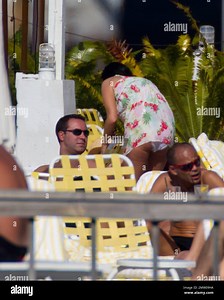 X Factor' judge Tulisa Contostavlos was seen taking time away from the recording studio to relax and take in the Miami sun. Tulisa showed off her figure in a flower pattern white bikini and a matching flower pattern cover up. Tulisa is in town recording her up and coming solo album as well as to film her first solo music video. Miami Beach, FL. 23rd February 2012 Stock Photo - Alamy