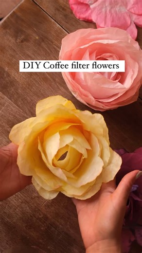 Sibia Torres Padilla | DIYs on Instagram: "We started by combining 4 coffee filters at a time We made a mixture of water and food coloring to dip them in. We also cut petals out of some of them. For the roses you can fold 3 times and cut a rounded top If you’re making ranunculus or peony you don’t have to cut at all. To make a carnation you’re going to want to fold 3 times and then round off at the end to make your petals. For a poppy you’ll fold the coffee filter twice and cut a rounded top. Th