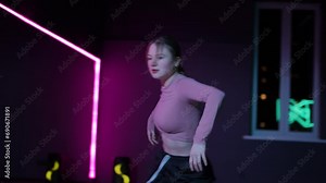 Live camera. A girl dancing Contemporary in a choreographic hall with neon illuminated mirrors