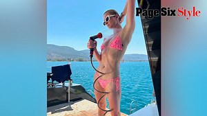 Paris Hilton Hoses Herself Down In A Leopard Swimsuit While Vacationing In Greece- ‘Bikini Barbie’aParis Hilton hoses herself down in a pink leopard-print swimsuit: 'Bikini Barbie'