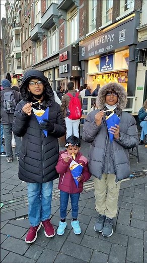 Tasting the famous Manneken Pis fries in Amsterdam—crispy, delicious, and a must-try street food!