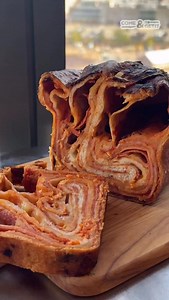 Lasagna meets pizza meets bread - @dannylovespasta’s Sicilian-inspired Scaccia Ragusana layers sauce, cheese, and pepperoni inside a crisp, golden loaf. Slice it open, and behold the ripple effect. Recipe at the link in bio. #f52community | Food52