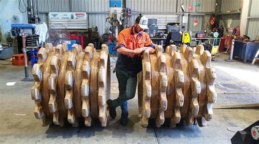 Replacing damaged caps on Caterpillar 815 soil compactor wheels