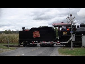 Vintage Steam Locomotive reverses through crossing with old gates