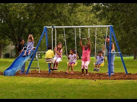 The kids play swing with friends at the park - Happy Kids without gadgets