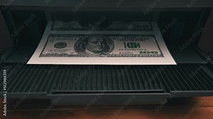 Print on a counterfeit one hundred dollar bill. Fake money, illegal actions. Illegal printing of money. American dollars print on A4 sheet.