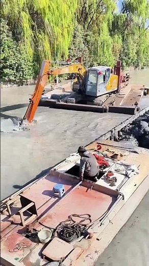 Floating Excavator Digging Riverbed Silt – Loaded Directly into Small Boat