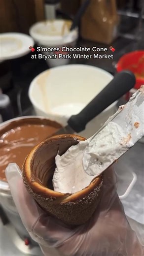 New York | New York on Instagram: "Come by Bryant Park Winter Village for a warm and delicious Campfire S’mores Chimney Cone! 🪵🏕️🤎 📸📸📸 @chimney.nyc"