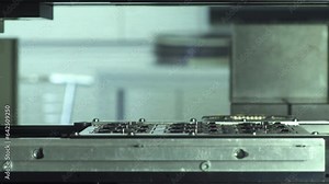 Advanced robotic arm assembling electronic components parts on circuit board close up. microchips factory with precision robotics technology in action.