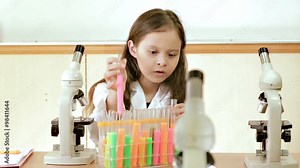Child scientist doing experiments in science lab