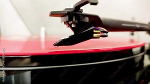 Retro Turntable System Playing a Red Vinyl Record. Close up View of the Stylus Needle on the Vintage Spinning Vinyl LP. 4K Video Footage. Stock Video
