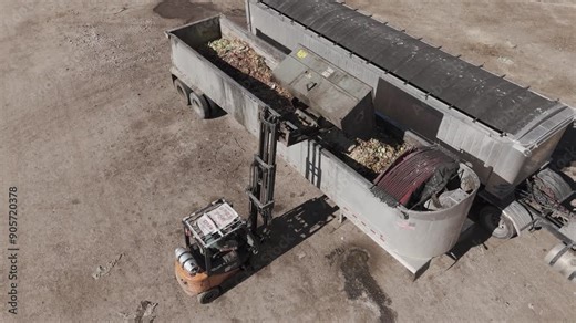 Food waste management aerial birds eye view, a forklift dumps food waste to be made into compost