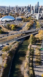 Aerial vertical autumn downtown landscape with traffic on bridge with sports centre in Calgary Alberta Canada.