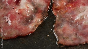 Cooking American fat smash burger on grill close-up. Beef or pork cutlet smashing by burger press. The chef in kitchen of the restaurant making cutlets for burgers - smash burger beefsteak. Fast and