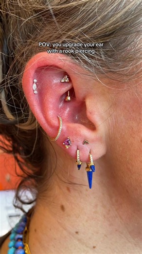 A rook piercing isn’t for the faint of heart but is the ultimate cool piercing and provides a lot of balance to an ear stack ⚡️ Book your rook piercing with the link in our bio📲 🪡 Rook & upper lobe piercing by @piercings.byheather in Dallas | Wildlike