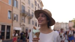 Beautiful woman sightseeing in Rome while enjoying a delicious gelato...