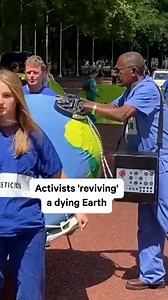 60K views · 137 reactions | Activists from protest group Extinction Rebellion gathered outside Her Majesty’s Treasury in London on Saturday to push for an end to fossil fuel investments. The non-partisan movement, which works to persuade governments to act justly on climate and ecological emergencies, dressed up as doctors and tried to ‘revive’ a model of a dying Earth using defibrillators in protest. | NowThis Earth | Facebook