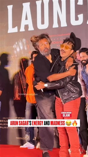 Sandalwoodglam on Instagram: "Arun Sagar never misses a chance to entertain! His presence added full fun and energy to the Mark trailer launch event. #sandalwoodglam #arunsagar #mark #trailerlaunch #entertainment #kannadacinema #sandalwood #stars #celebritystyle #mysore #bengaluru #eventvibes #reels #viral #kannadastars #filmyvibes #movieevent #celebritybuzz #fanslove #cinematicvibes #specialmoments #starvibes #filmindustry #eventhighlight #funmoment #buzz #cineworld #marktrailer #energy"