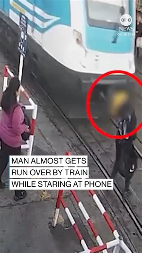 40K views · 443 reactions | Surveillance footage captured a terrifyingly close call as a pedestrian crossed train tracks while staring at his phone in Buenos Aires, Argentina. https://abcnews.visitlink.me/gGFIlR | ABC News | Facebook