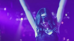Woman in mask in night club