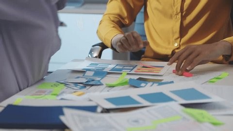 clip-4011035645-team-uxui-designers-pointing-computer-screen-discussing