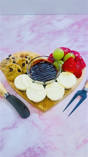 Oh My Ganache on Instagram: "❤️ Heart of Ganache – Valentine’s Dessert Board ❤️ Fall in love at first bite. Our signature Heart of Ganache is a luxury, heart-shaped dessert charcuterie board filled with: 🍪 Chocolate chip cookies 🍰 Cheesecake bites — your choice of flavors 🍓 Strawberries & grapes glazed with a white peach fruit glaze 🍫 Served with your choice of White Chocolate Ganache or Chocolate Ganache ✨ Each order includes a keepsake heart-shaped charcuterie b