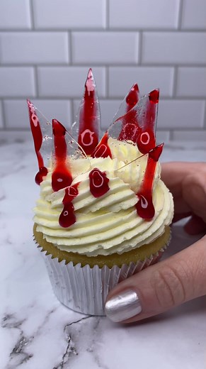 Be careful of the broken glass 🩸🩸😜 @cakedbyrach pairs broken "glass" with Wilton fake blood glaze for a spectacularly spooky effect. #wiltoncakes #cupcake #cupcakestagram #cupcakeart #cupcakedecorating #halloween #halloweenbaking #fakeblood #spookytreats #halloweenparty #halloweenpartyfood | Wilton Cake Decorating