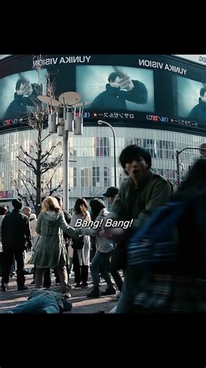 The moment the young man shouts "Bang! Bang!" in the middle of the crowded intersection as people ar