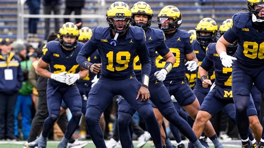 Michigan players protect 'Block M' logo from Ohio State flag plant